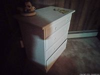 Front and side view of white baby dresser