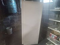 Front view of closed GE upright freezer