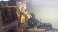 Overall view of yellow Powertec Power Gym with bench and lever arms