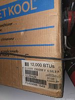Box end showing 12,000 BTU, 8.5 EER, voltage and model 12JW42K label