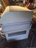 Side view showing accordion side panels and vented casing