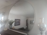 Full view of round mirror showing frame and reflection
