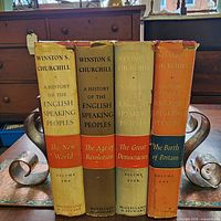 Spines of all four volumes showing titles, author, publisher, dust-jacket wear