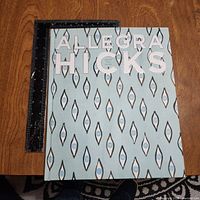 Front cover showing title and design, ruler alongside for scale