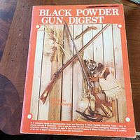Front cover of Black Powder Gun Digest softcover showing title, imagery and wear