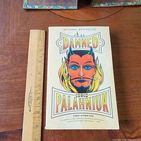 Front cover of Damned trade paperback with ruler for scale