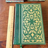 Front cover with ruler for scale showing decorative gilt design