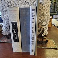 Spines of three books visible: Elizabeth I, King Edward VIII, Diana