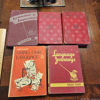 All five textbooks laid out on table