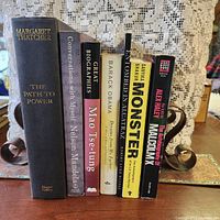 Spines of all seven biography books displayed upright