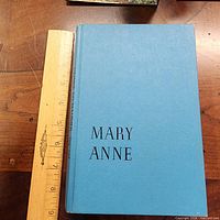 Front cover with ruler showing size, blue cloth boards, title text