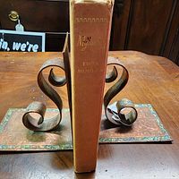 Spine view of cloth hardcover showing title and wear