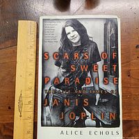 Front cover of paperback with ruler for scale