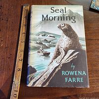 Front view of book showing cover art and ruler for scale