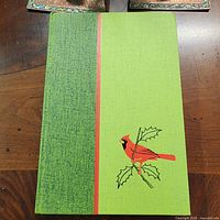 Front cover of green cloth hardcover with cardinal illustration