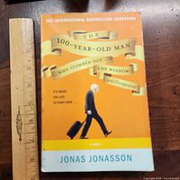 Front cover with ruler for scale showing full title, author and artwork