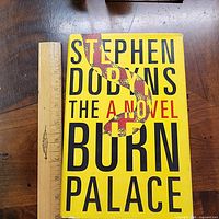 Front cover of The Burn Palace hardcover with ruler for scale
