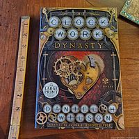 Front cover showing title, author, large print sticker, and gear artwork