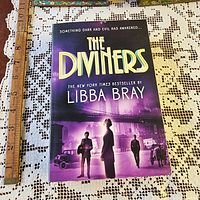 Front cover of The Diviners paperback with ruler for scale