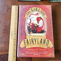 Front cover of the book with ruler for scale