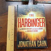 Front cover of The Harbinger with ruler for scale