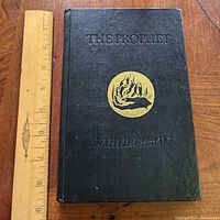 Front cover showing title, emblem, ruler for scale