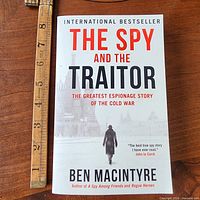 Front cover with title and author visible, ruler for scale