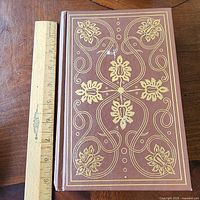 Front cover showing gold foil decorative design with ruler for scale