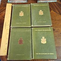 All four Tudor Shakespeare volumes front covers with ruler for scale