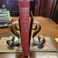Spine view of red cloth hardcover book between bookends