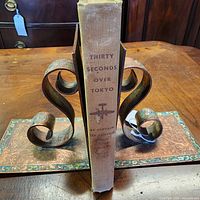 Spine of book showing title, author, publisher and visible wear