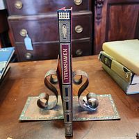 Book spine showing black leather with gilt title and decoration