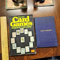 Front covers of both books with ruler for scale