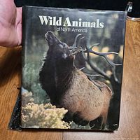 Front cover with dust jacket displaying elk image and title