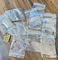 Multiple clear bags containing pendant, earrings, hair comb, charms