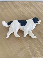 Left side view of black & white Newfoundland dog figurine