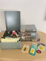 overview with metal box open, drawer units, packaged notions, patches visible