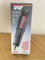 Front of box showing Milwaukee Precision Hot Tool model 1400 and feature list