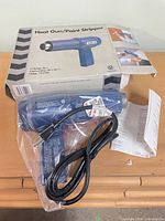 Heat gun, cord, paperwork and box overview