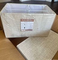 Front of lamp shade showing fabric and brand label