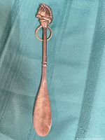 Full view of brass spoon showing entire length and bowl