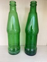 Front view of both green glass bottles