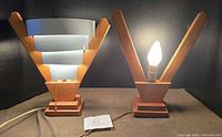 Pair of lamps, one illuminated showing design and function