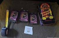 Group of sealed packs beside the original display box