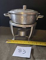 assembled chafing dish on stand with tape measure for scale