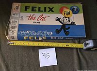 Top view of Felix the Cat Game box with tape measure for scale