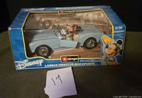 Front-left view of boxed diecast car; shows product branding and Mickey Mouse driver