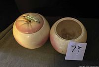 Two apple cookie jars, one with lid displayed side by side