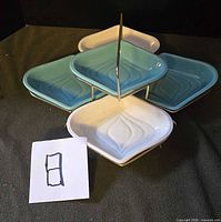 Five ceramic dishes on two-tier metal rack, showing colour contrast and MCM design