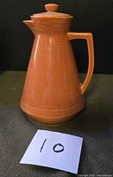 Front view of ceramic coffee pot with lid